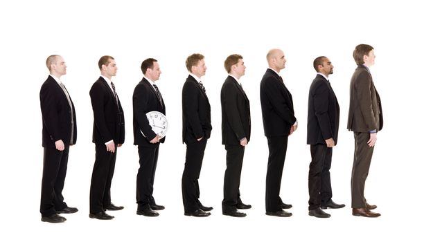 Man holding a clock standing in a line