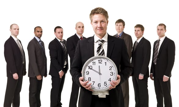 Business manager with a clock in front of his team