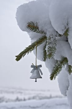 This image shows a little silver bell for a Christmas Tree
