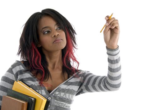 girl with books and looking to pencil against white background