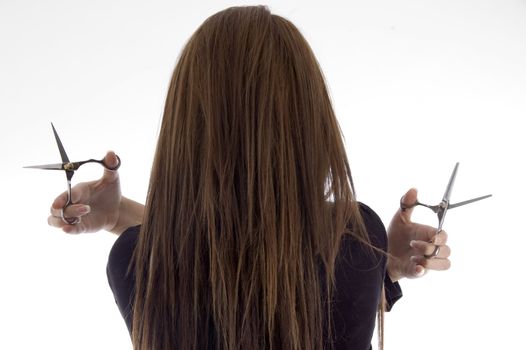 back pose of female with scissors with white background