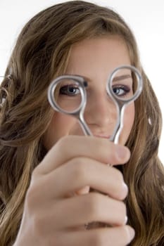 girl looking into scissors on an isolated background