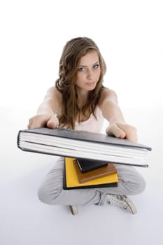 sitting girl showing book against white background