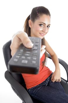 sitting girl showing remote on an isolated white background