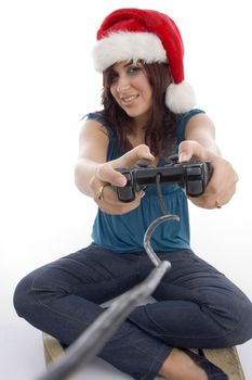 young woman with remote and christmas hat on an isolated white background