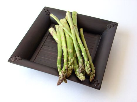 Bunch of asparagus on black plate