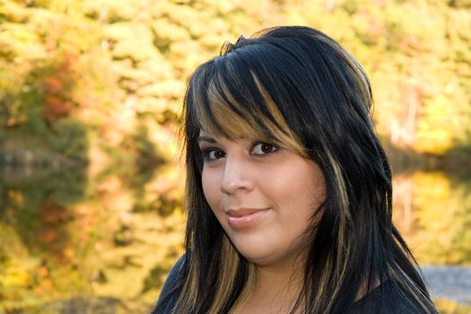 A young woman with highlighted hair in a new england setting during autumn.