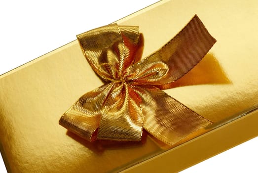 A gold boxed gift with gold ribbon