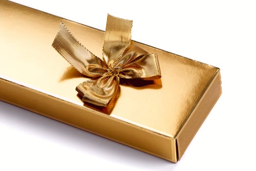 A gold boxed gift with gold ribbon
