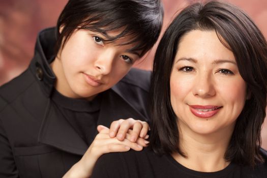 Attractive Multiethnic Mother and Daughters Studio Portrait.