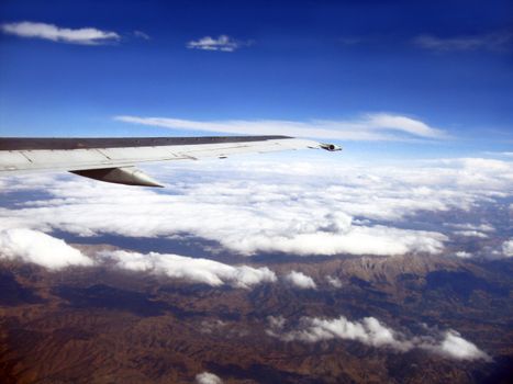 mountains and airplane wing viewing from a plane