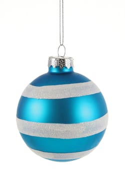 A single isolated blue striped Christmas bauble hanging.
