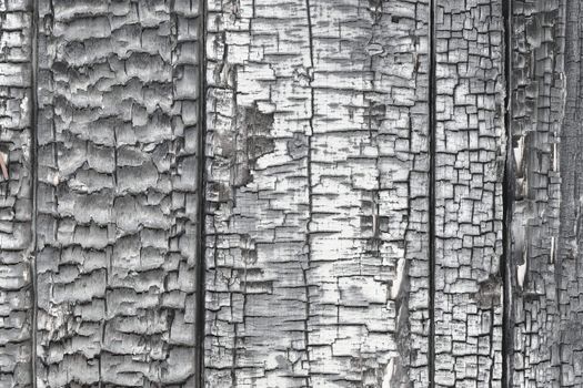 The wooden wall is damaged by fire