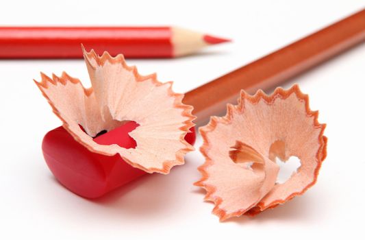 With a red pencil-sharpener and shavings.