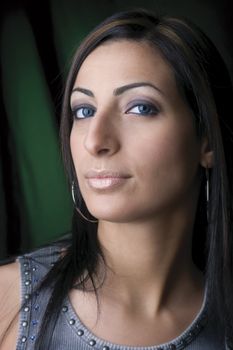 Closep up of a twenty something fashion model with a green and black background