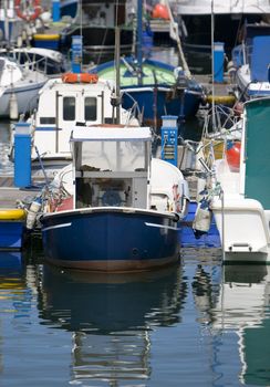 boat resting in paceful water in the dock harbor of Santurce near Bilbao