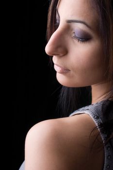 Head shot portrait of a twenty something fashion model looking over her shoulder