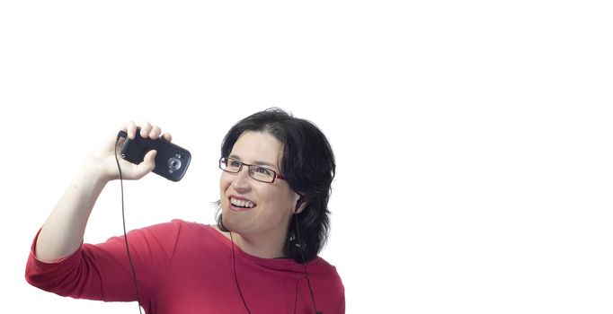 young woman listening, dancing and singing to music in a mp3 device