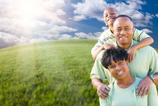 Happy African American Family Over Clouds, Sky and Arched Horizon of Grass Field.