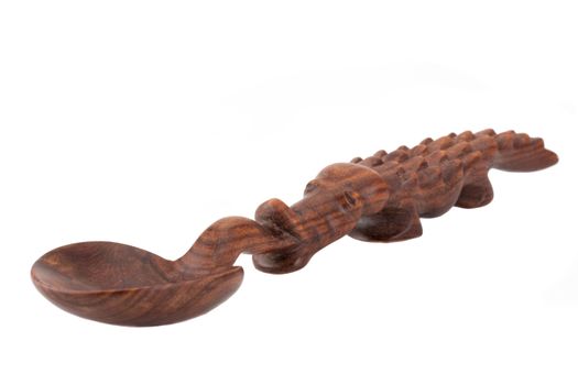 a carved spoon in the shape of a crocodile