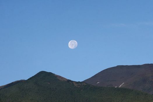 Moon setting over Rocky Mountains