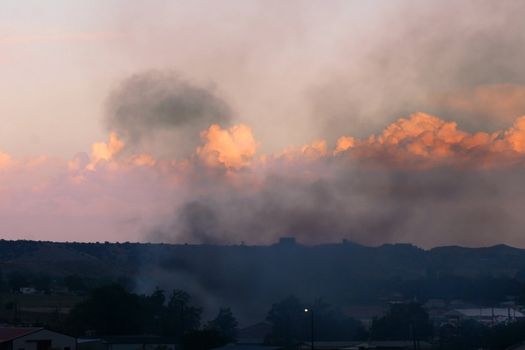 Smoke from out of control grassfire adds to the color of the sunset