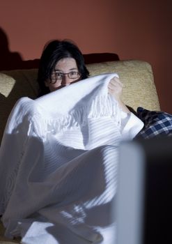 woman watching a halloween horror movie in the tv in a room