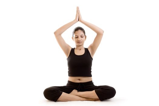 Young woman doing exercise over white background in black dress 