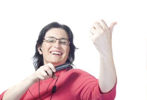 young woman listening, dancing and singing to music in a mp3 device