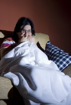 woman watching a halloween horror movie in the tv in a room