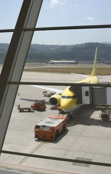 in the airport a plane refueling taken from the terminal