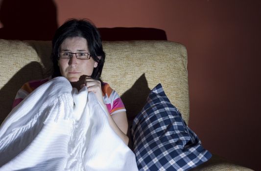 woman watching a halloween horror movie in the tv in a room