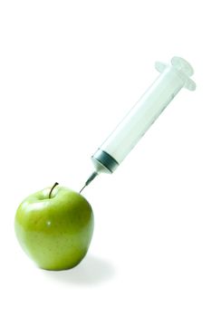 Concept image of a large needle injecting an apple with vitamins, isolated against a white background.