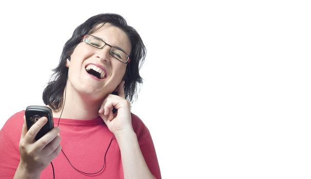 young woman listening, dancing and singing to music in a mp3 device