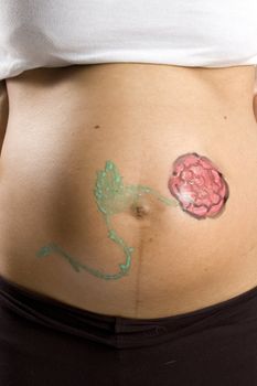 30 weeks pregnant teenager with a flower on her belly