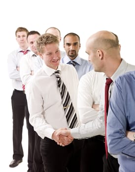 Businessmen shaking hands standing in a group