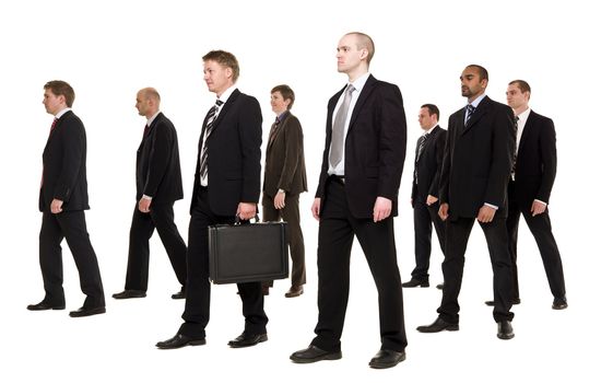 Group of businessmen walking in the same direction