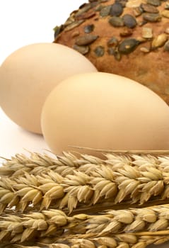 Still Life with ears of wheat, eggs and white bread