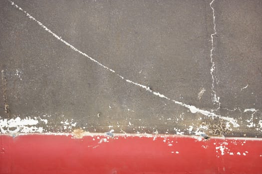 Abstract of concrete with crack and red line.