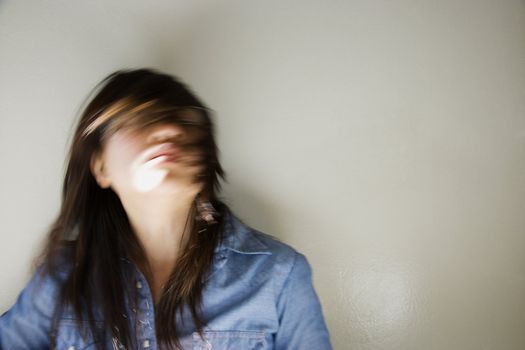 Pretty young Asian woman with swinging head and hair around.