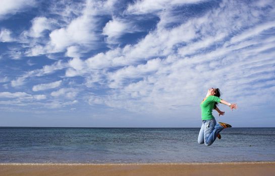 Woman jumping on the beach