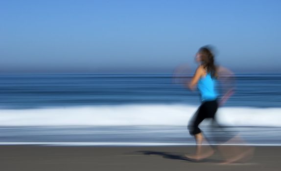 Motion efect picture of girl running on the beach