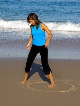 Woman making drawings on the sand