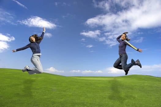 Woman's jumping on the green field