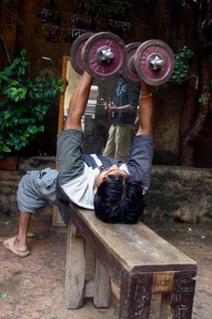 a young, strong boy in india gym