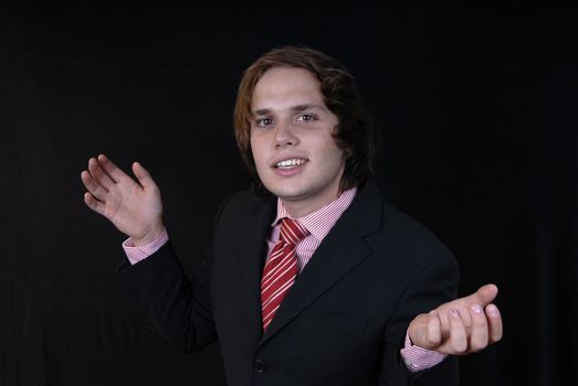 young business man portrait on black background