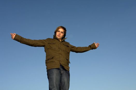 man with open arms with the sky as background