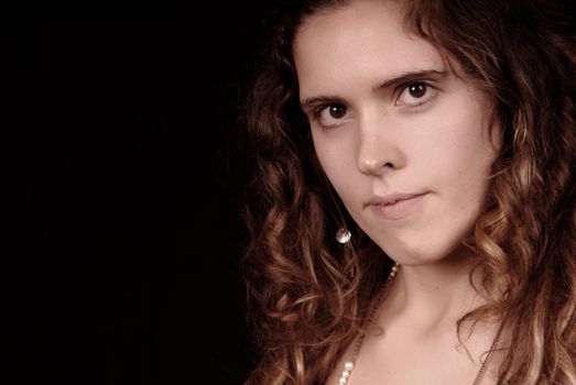 Young woman portrait posing in black background