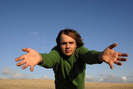 man with open arms with the sky as background