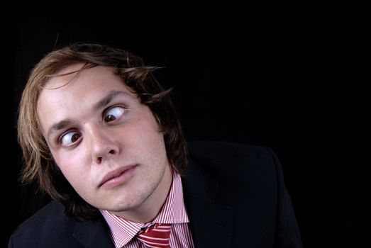 crazy young man portrait isolated on black